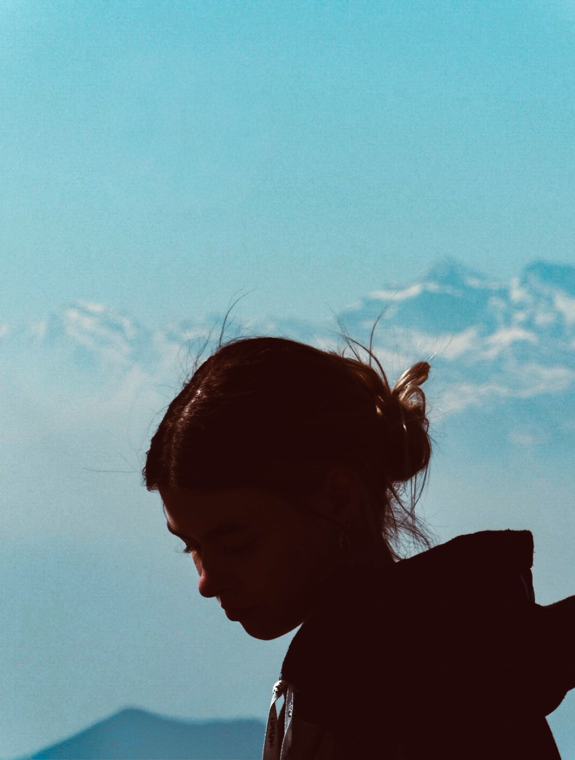 Silhouette portrait against a blue sky