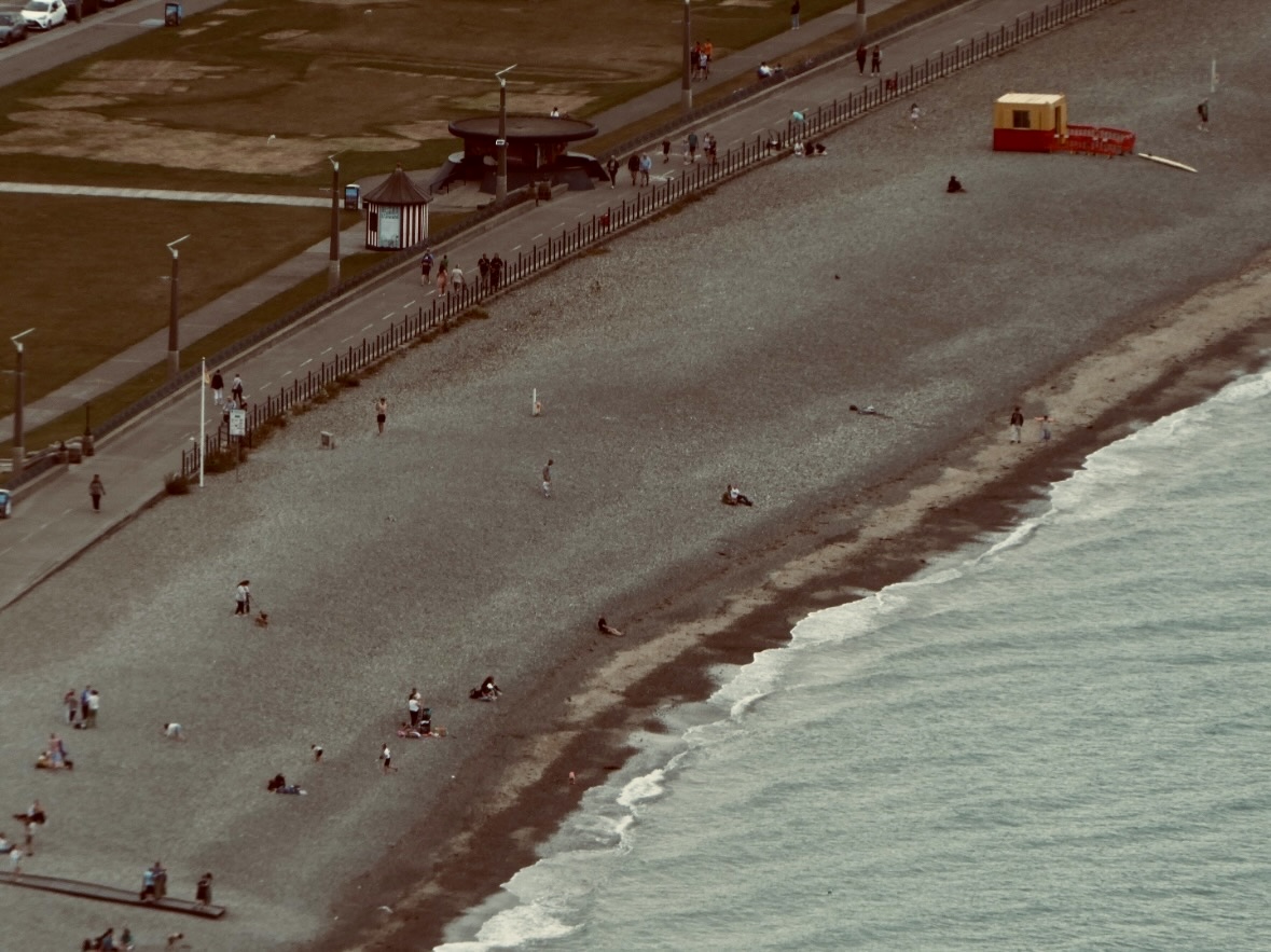 Elevated view of people scattered along a shoreline