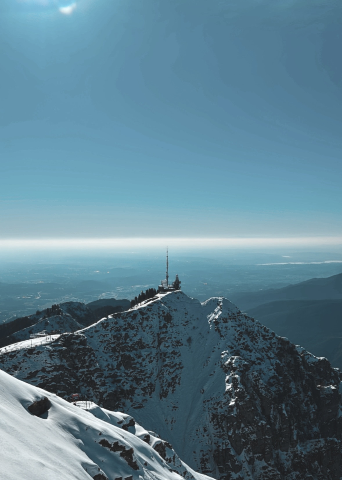 Snow-covered mountain ridge beneath a blue sky